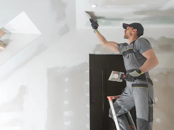 Professional drywall repair during home interior remodeling project.